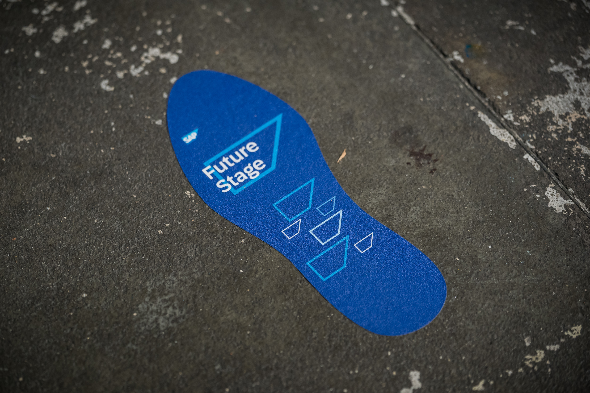 Footprint-shaped floor sticker labeled “Future Stage”. Wayfinding element on the event grounds at the SAP Partner Summit.